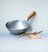 A wok and wooden spoons