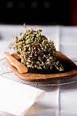 Dried herbs on a wooden board