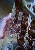 Chocolate pralines being made