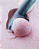Strawberry ice cream and an ice cream scoop