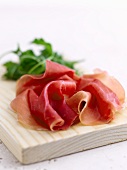 Slices of Parma ham on a chopping board