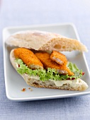 A fish finger sandwich with lettuce and mayonnaise