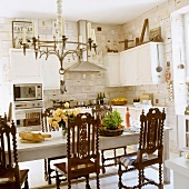 Lunch in Scandinavian kitchen with antique wooden chairs around dining table
