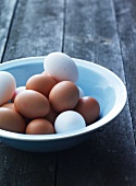 A bowl of white and brown eggs