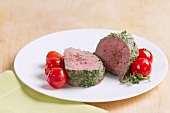 Steamed veal fillet with a herb coating and cherry tomatoes