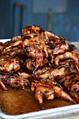Whole Roasted Quails Piled on a Sheet Pan with Pan Drippings