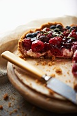 Berry tart, a piece removed