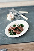 Lamb chops on a bed of spinach