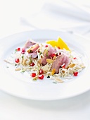 Rice salad with duck, almonds and pomegranate seeds
