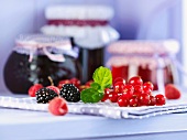 An arrangement of berries and jellies in jars