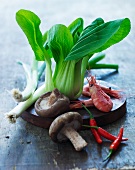 An arrangement of vegetables, mushrooms and prawns