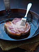 A pork chop in a pan
