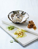 An oyster with various salsas