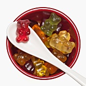A bowl of organic gummibears with a spoon