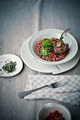 Risotto with pomegranate seed and a roast lamp chop