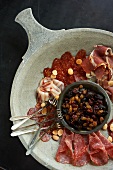 Mostarda and Charcuterie on a Stone Plate with Marcona Almonds and Small Forks; From Above