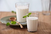 Two glasses of milk on a wooden table