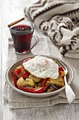 Gröstl (typical Tirolean dish using leftovers - here: fried potatoes with vegetables and a fried egg)