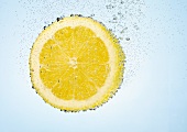 A lemon slice in water with air bubbles