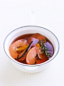 Quinces, a vanilla pod and rosemary in syrup