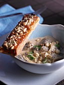 Morel mushroom soup with a slice puff pastry