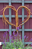 Wicker heart on trellis in garden