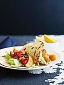 Fajitas with fish, tomato salsa and guacamole