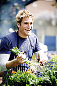 A chef with fresh garden vegetables