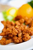Deep Fried Clams on a White Plate; Close Up