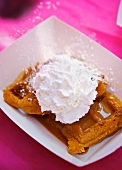 Peanut Butter Maple Waffles with Whipped Cream and Powdered Sugar Sprinkling On the Top