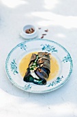 Wolffish with basil puree wrapped in aubergine