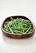 Frozen green beans in a wooden bowl