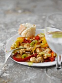 Chicken with stir-fried vegetables and white bread