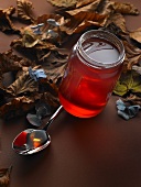 Apple jelly in a jar with a spoon