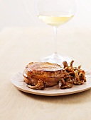 A veal medallion with chanterelle mushrooms