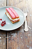 A slice of rhubarb cream cake with red currants