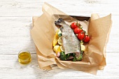 Stuffed trout with vegetables in foil (raw)