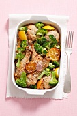 Chicken legs with lemon, broccoli and sesame seeds