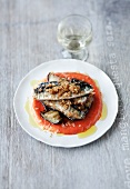 Sardines on a bed of aubergines with a pepper sauce