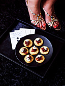 Spicy canapes topped with caramelised onions and goat's cream cheese