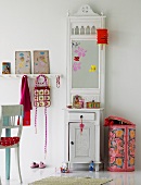 White hallstand with mirror and storage bin with colourful cover