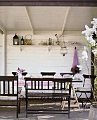 Seating area on roofed terrace of wooden house