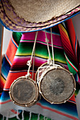 Small drums and ethnic blanket hanging on wall