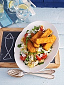 Spicy fish fingers with a pasta salad