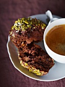 Mini chocolate and coconut cakes with pistachios and a cup of coffee