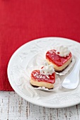 Two heart-shaped cakes with a cream filling and a red jelly topping