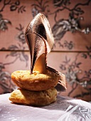 A high heeled shoe on a loaf of bread