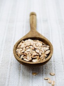 Spelt flakes on a wooden spoon