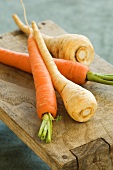 Carrots and parsnips on a wooden board