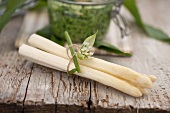 A bunch of white asparagus wrapped in ramsons